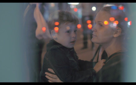 Tired Boy Giving Hug to Mother at Bus Stop - Stock Video