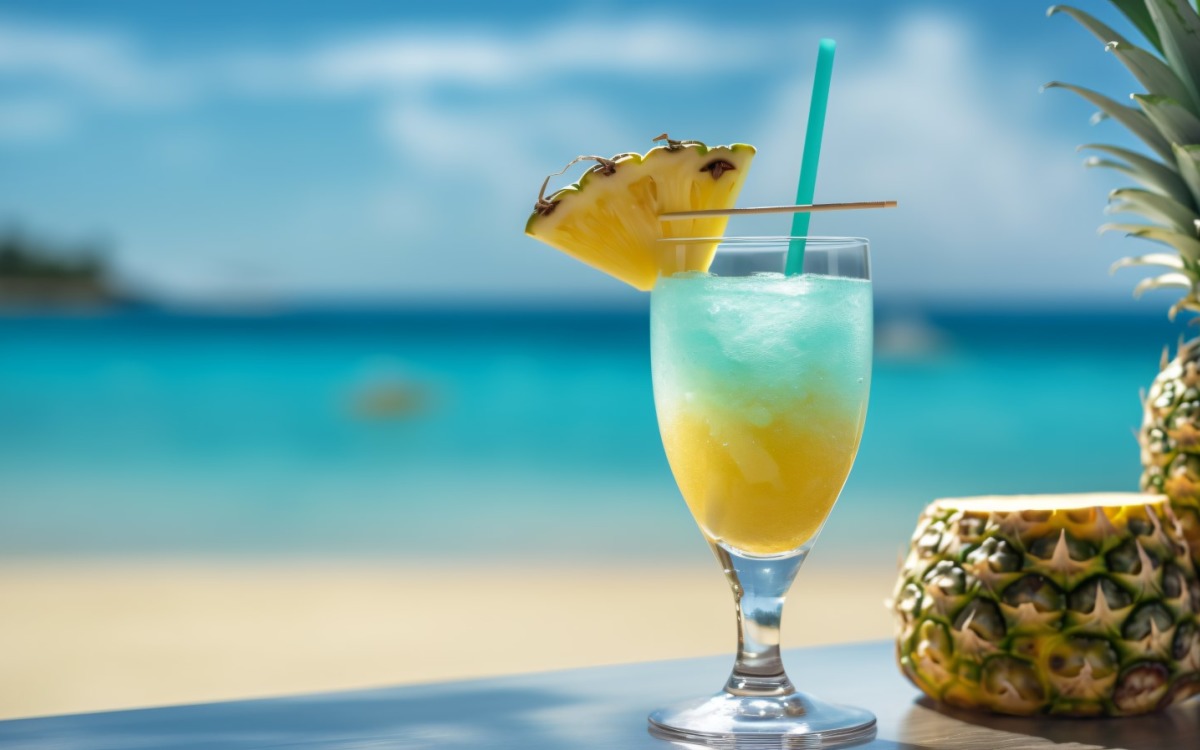 Pineapple drink in cocktail glass and sand beach scene 121