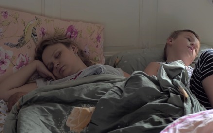 Sleeping mom, baby and elder son in bed people Stock Video