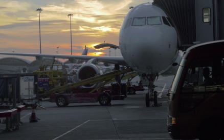 Boarding and loading airplane at sunset vehicles - Stock Video