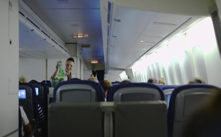 Stewardess giving drinks to passengers vehicles - Stock Video
