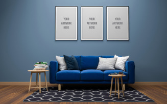 Three empty photo frames with blue sofa in interior living room product mockup