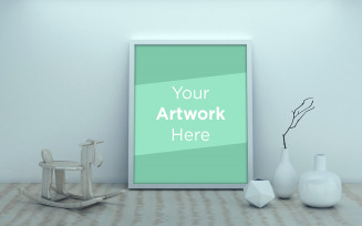 Blank vertical poster frame mock up standing on table next to white wall with vases product mockup