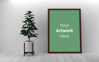 Blank wooden photo frame by the houseplant on a floor product mockup