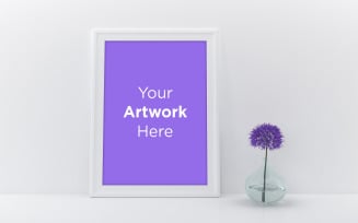 Empty white frame mockup with purple flower in clear glass vase product mockup