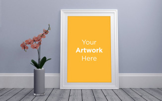 White empty frame mockup with flower laying on floor product mockup