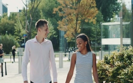 Multi-ethnic couple shyly looking at each other while - video footage Stock Video