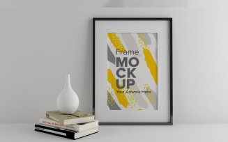 Frame Mockup with books and Vases on a white wall Mockup Template