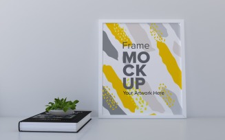 A Closeup Shot Of A White Frame With A Book On The Shelf Mockup Template
