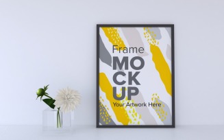 Black Frame With Decorative Flowers On A Gray Wall Background Mockup Template