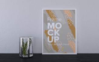 Decorative Plant Next To A White Frame On A Gray Wall Mockup Template