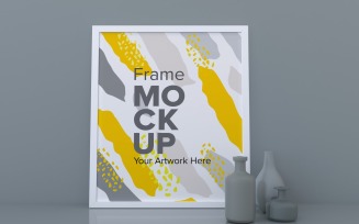 White Frame On A Gray Wall With Vases On A Shelf Mockup Template