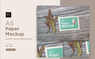 A5 Paper Mockups With Dry Leaves and pinus leaves and Green leaves on Wooden background