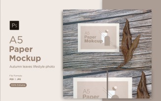 A5 Paper Mockups With Dry Leaves and pinus leaves on Wooden background