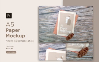 A5 Paper Greeting card Mockups With Conifer cone on Wooden background