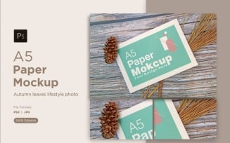 A5 Paper Mockups With Conifer cone and pinus leaves on Wooden background