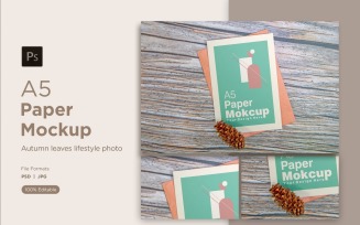 A5 Paper Mockups With Conifer cone on Wooden background