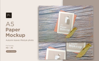 A5 Paper Mockups With Green Leaves on Wooden background