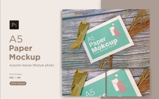 A5 Paper Mockups With pinus leaves and Green Leaves on Wooden background