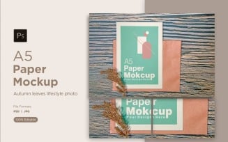 A5 paper greeting card mockup with pinus leaves on wooden background