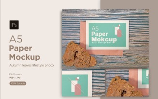 A5 Paper greeting card Mockups With Brown stones on wooden background