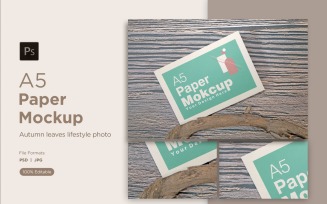 A5 Paper greeting card Mockups With driftwood on Wooden background