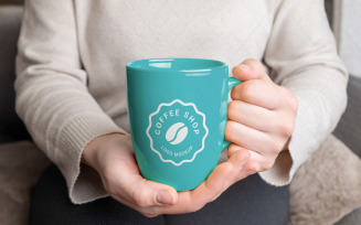 Girl holding a mug with changeable colors and logo mockup