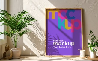 Poster Frame Mockup with decorative items on the table 04
