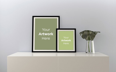 Two vertical blank photo frames mockup with plant in glass vase on the cabinet product mockup