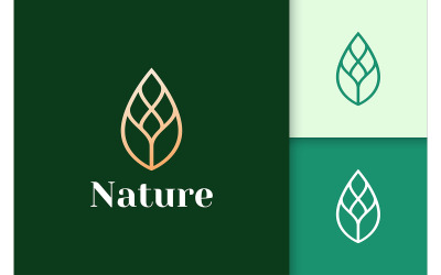 Logotipo de hoja de oro en lujo y elegante para la belleza y la salud