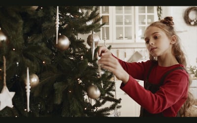 A Girl Busy Arranging The Ornament Decors Hanging In A Christmas Tree Stock Video