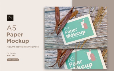 A5 paper greeting card mockup with mimosa tree seed and pinus leaves on wooden background