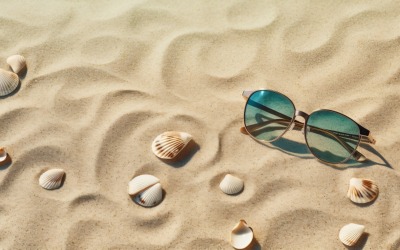 Solglasögon snäckskal och strandtillbehör på sandstrand 200
