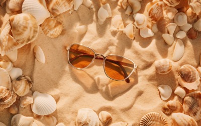 Sunglasses seashells and beach accessories on sandy beach 196