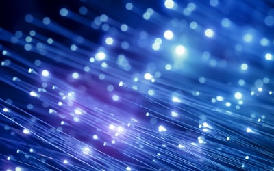 Blue light dots from optic fiber lines over dark background
