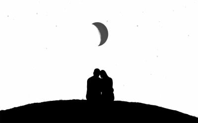 Silhouette of romantic couple kissing on hill at night under crescent isolated on white background