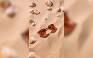 Sunglasses seashells and beach accessories on sandy beach 185