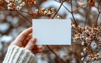 White Paper Held Against Dried Flowers Card Mockup 366