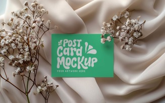 Post card mockup with dried flowers on the silk cloth 305