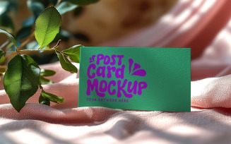 Postcard mockup with plant branches on the silk cloth 315