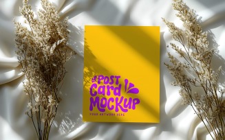 post card mockup with dried flower on the silk cloth 325