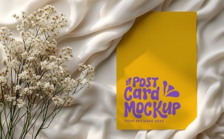 Post card mockup with dried flowers on the silk cloth 385