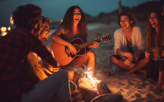 Blurred group of young people having fun at night playing guitar singing songs