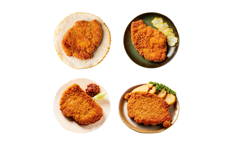 Panerad schnitzel på en tallrik isolerad på vit bakgrund.